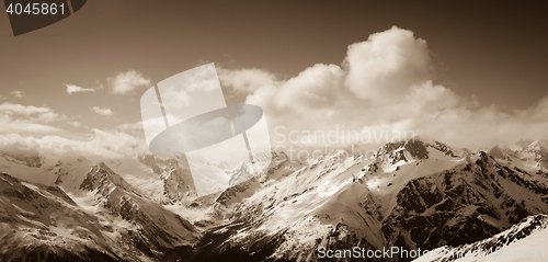 Image of Panorama of sunny winter mountains in clouds