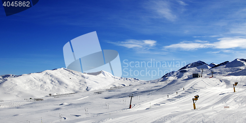 Image of Panoramic view on ski slope with snowmaking at sun day