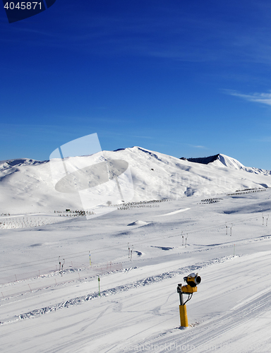 Image of Ski slope with snowmaking at sun day