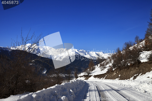 Image of Ice-covered road in winter snow mountain at sun cold morning