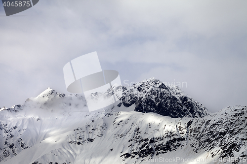 Image of Snow sunlight mountain in fog at gray day