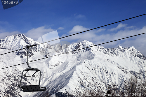 Image of Chair-lift in snow winter mountains at nice sunny day
