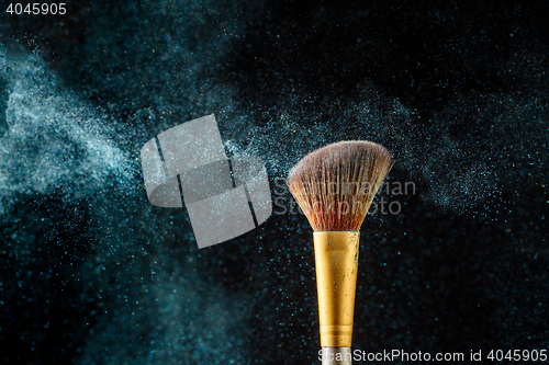 Image of Brush with crumble shadows on black empty background