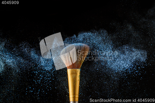 Image of Brush with blue shadows shade on black background