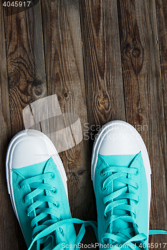 Image of sneakers on empty wooden surface