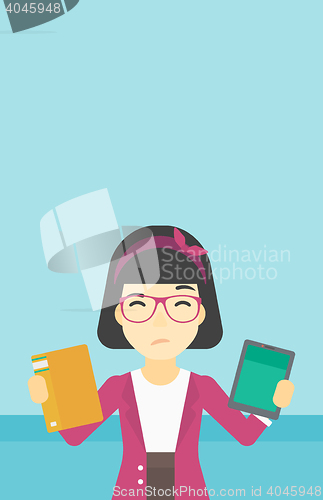 Image of Woman choosing between book and tablet computer.