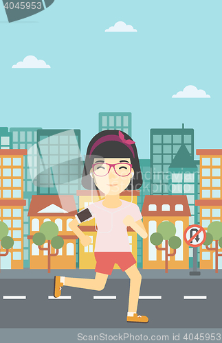 Image of Woman running with earphones and smartphone.