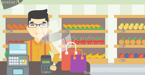 Image of Man paying wireless with smart watch.