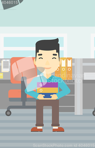 Image of Businessman holding pile of folders.