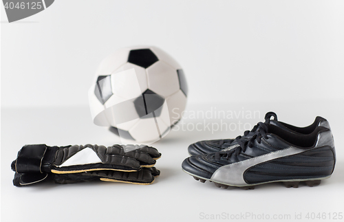 Image of close up of goalkeeper gloves, ball, soccer boots