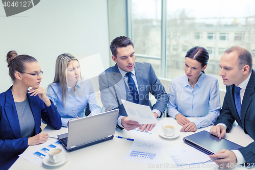 Image of business team with laptop having discussion