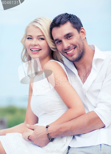 Image of couple in shades at sea side