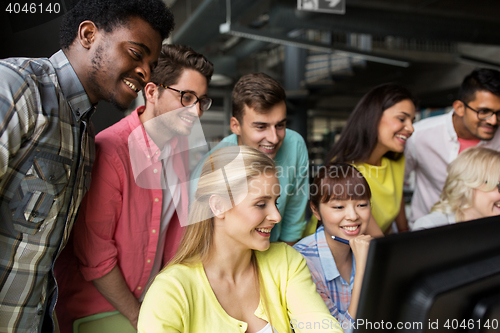 Image of international students with computers at library