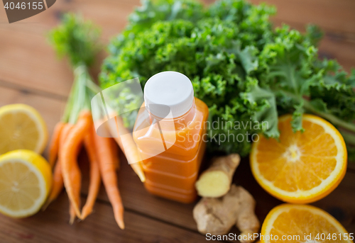 Image of bottle with carrot juice, fruits and vegetables