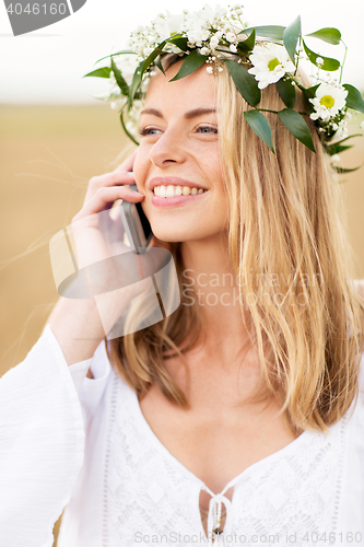 Image of happy young woman calling on smartphone at country