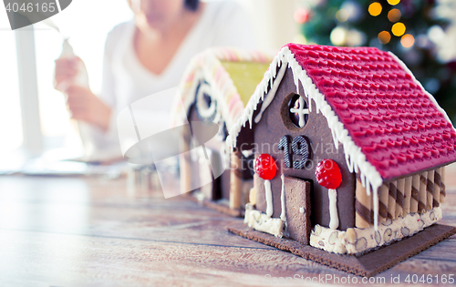 Image of close up of woman making gingerbread houses