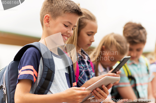 Image of group of happy elementary school students talking