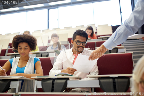 Image of teacher giving tests to students at lecture