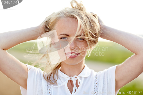 Image of close up of happy young woman in white outdoors