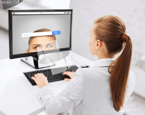 Image of businesswoman with internet search on computer