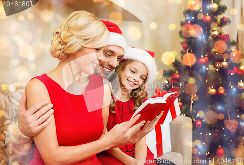 Image of smiling family reading book