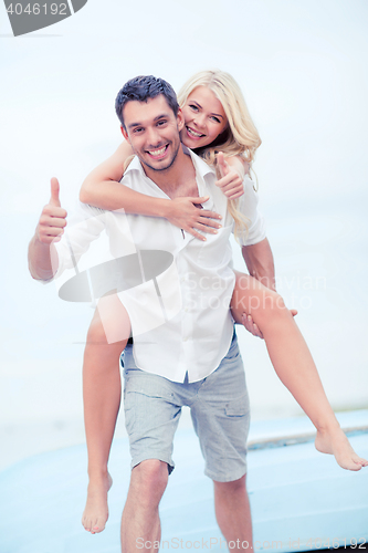 Image of couple having fun on the beach