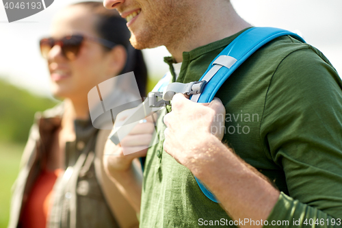 Image of close up of couple with backpacks hiking outdoors