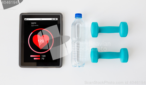 Image of close up of tablet pc, dumbbells and water bottle