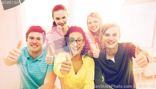 Image of smiling students at school showing thumbs up