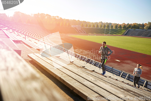 Image of happy couple running upstairs on stadium