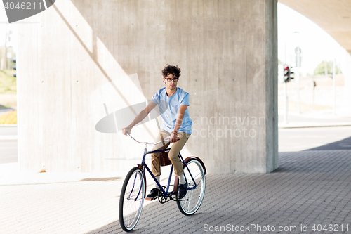 Image of young hipster man riding fixed gear bike