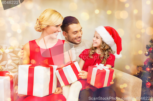 Image of smiling family holding many gift boxes