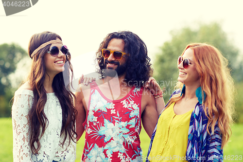 Image of smiling young hippie friends talking outdoors