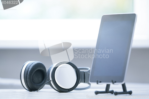 Image of Headphones and digital tablet at office