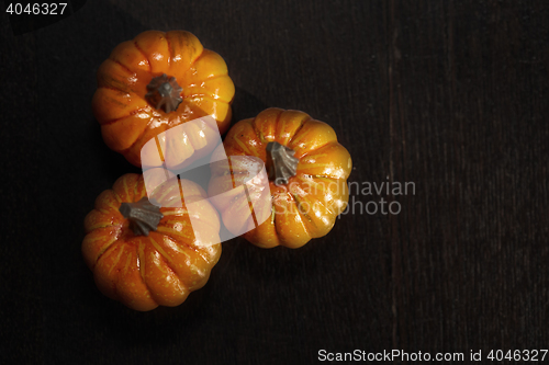 Image of Three pumpkins on a wooden table