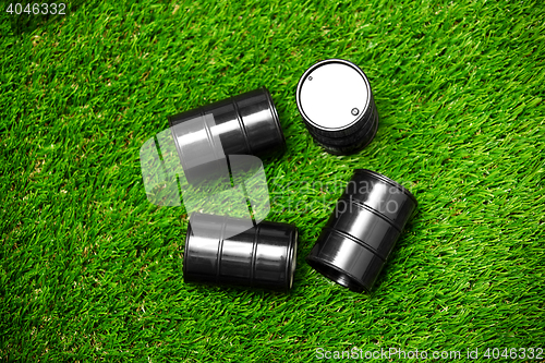 Image of High angle view on four oil barrels on a grass