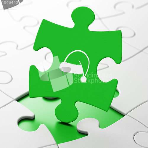 Image of Holiday concept: Christmas Hat on puzzle background