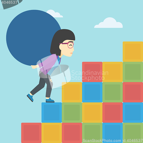 Image of Woman carrying concrete ball uphill.