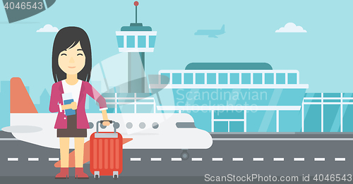 Image of Woman with suitcase and ticket at the airport.