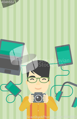 Image of Young man surrounded with his gadgets.