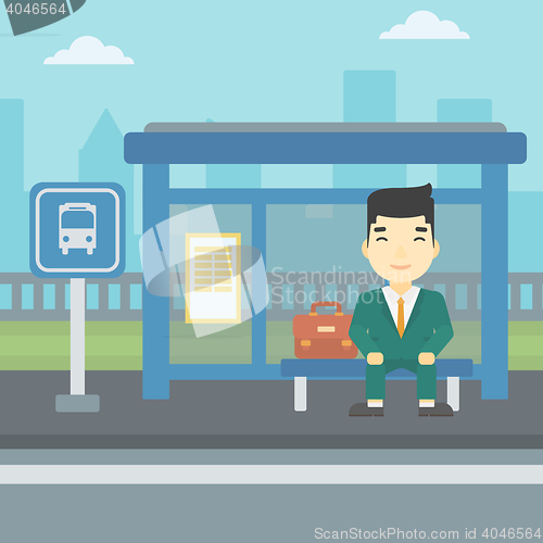 Image of Man waiting for bus at the bus stop.