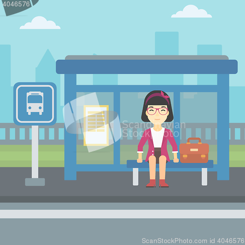 Image of Woman waiting for bus at the bus stop.