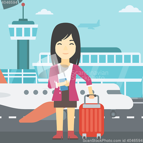 Image of Woman with suitcase and ticket at the airport.