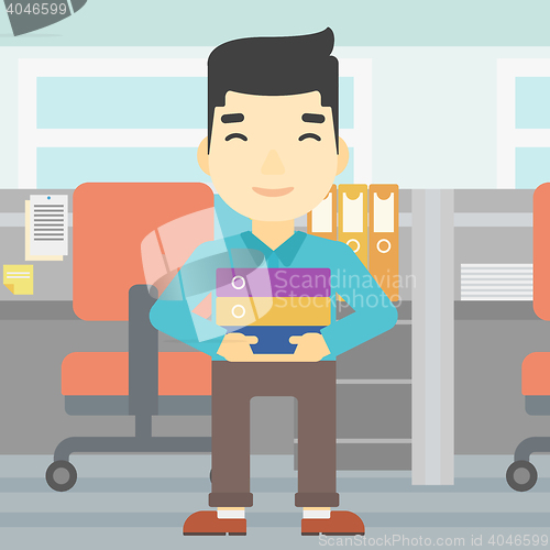 Image of Businessman holding pile of folders.