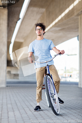 Image of young hipster man riding fixed gear bike