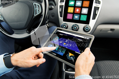 Image of close up of man with tablet pc in car