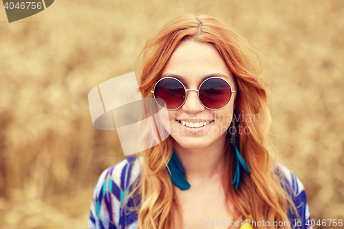 Image of smiling young redhead hippie woman outdoors