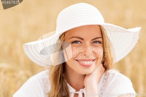 Image of close up of happy woman in sun hat on cereal field