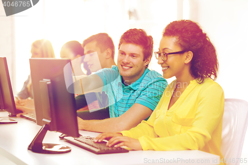 Image of smiling students in computer class at school