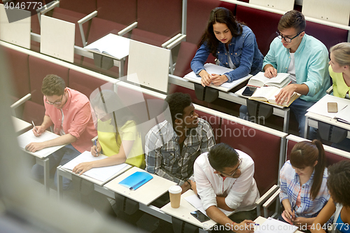 Image of group of students with notebooks at lecture hall